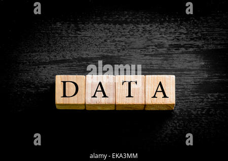 Word DATA. Wooden small cubes with letters isolated on black background with copy space available. Concept image. Stock Photo