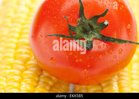 background of ripe yellow corn and tomato Stock Photo