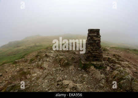 The Ordinance Survey Trig point at the summit of Loughrigg fell, Lake District National Park, Cumbria County, England, UK. Stock Photo