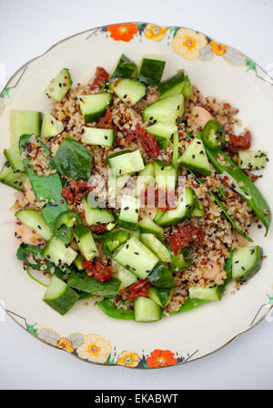 Quinoa Salad with sun dried tomato cucumber black sesame seeds Stock Photo