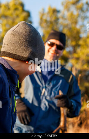 Father and son hiking in field Stock Photo