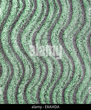 Sandy beach background. Sand texture with waves from the wind. Top view, summer background Stock Photo