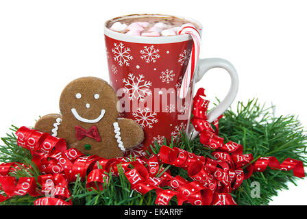 Christmas gingerbread man in ribbons with hot chocolate isolated on white. Stock Photo