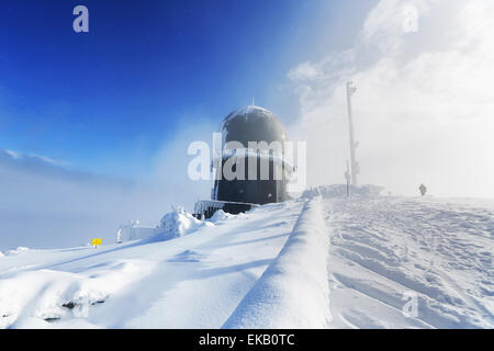 Ice-covered screen weather station, high on mountain-top, Germany Stock Photo