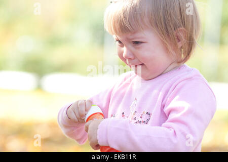 beautiful little girl crying on the autumn forest Stock Photo