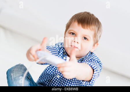 Boy playing on a game console Stock Photo