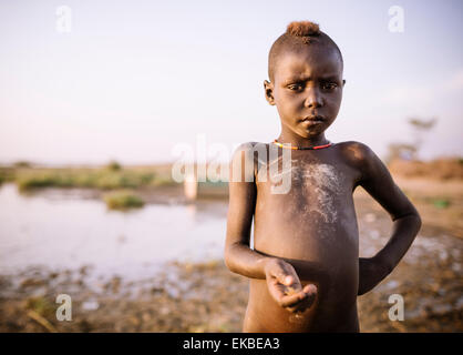 Children fishing on the shore of Turkana Lake, Dassanech Tribe, Omo Valley, Ethiopia, Africa Stock Photo