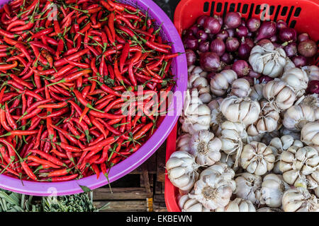 Red chillies, onions, and garlic for sale at fresh food market in Chau Doc, Mekong River Delta, Vietnam, Indochina, Asia Stock Photo