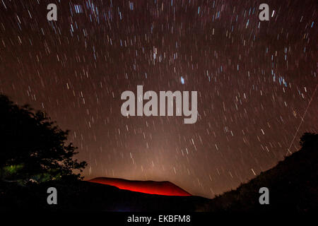 Glowing active volcanic crater of Volcan Telica at night with star trails and shooting star (meteor) on right, Leon, Nicaragua Stock Photo