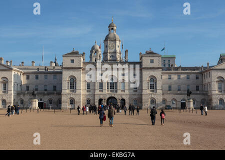 Tourists walk towards the arch of Horse Guards Parade under a winter's blue sky, Whitehall, London, England, United Kingdom Stock Photo