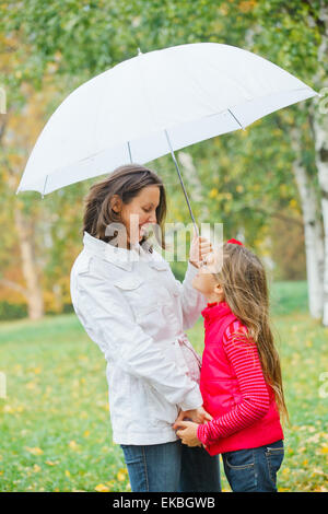 Cute girl with her mother walking in park Stock Photo - Alamy