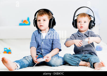 two brothers playing on a games console Stock Photo