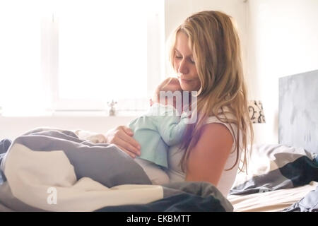 Baby is sleeping om mothers arms Stock Photo