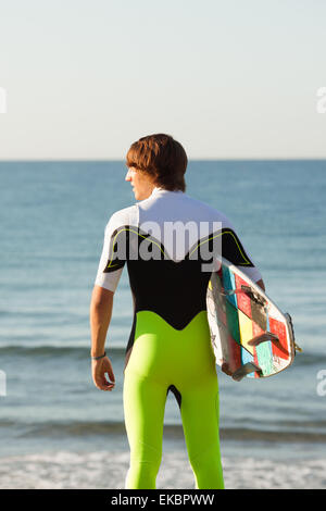 young surfer about to get into the sea Stock Photo