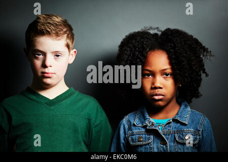 Portrait of a boy and girl looking serious Stock Photo