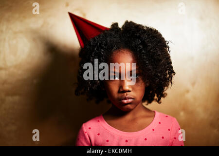 Sad girl wearing party hat Stock Photo