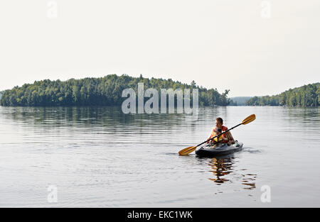 Father and son kayaking on lake, Ontario, Canada Stock Photo