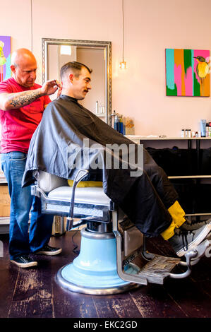 Young man having his hair cut Stock Photo