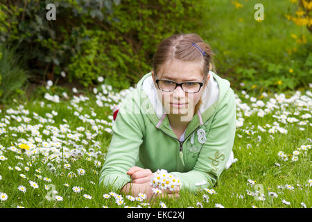 young girl picking daisies Stock Photo