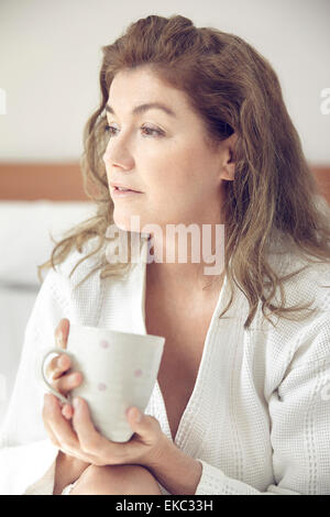 Portrait of mature woman holding mug Stock Photo