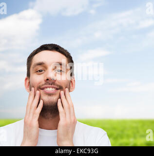 beautiful smiling man touching his face Stock Photo