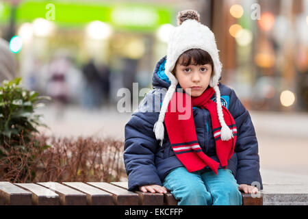 sad boy sitting on a bench Stock Photo - Alamy