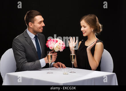 smiling man giving flower bouquet to woman Stock Photo