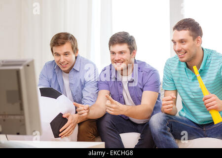 happy male friends with football and vuvuzela Stock Photo