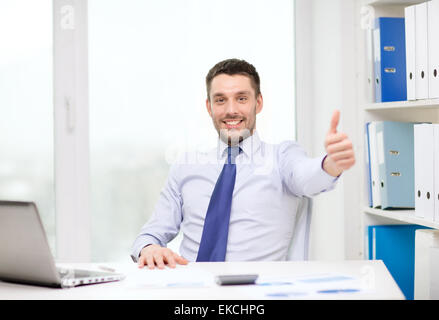 smiling businessman with laptop and documents Stock Photo