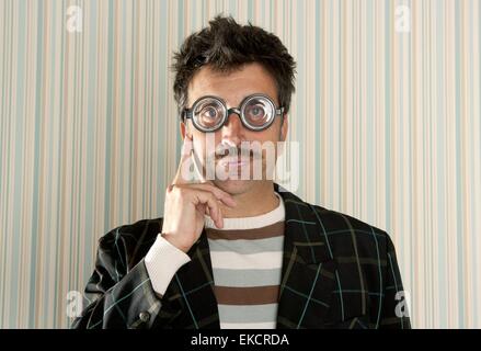 crazy nerd man myopic thinking funny gesture Stock Photo