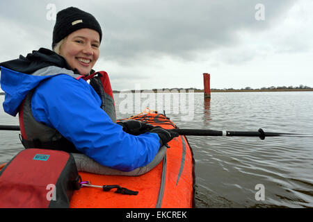 Young woman in Advanced Elements Convertible kayak on Hickling Broad, Norfolk, Broads National Park Stock Photo