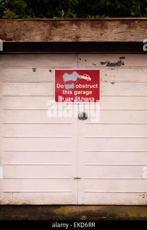 Do Not Obstruct This Garage in use 24 hours sing on a private garage in Bristol England UK Stock Photo