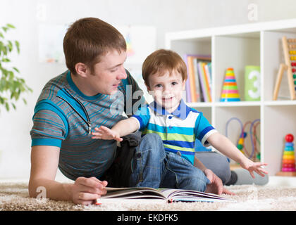 happy father read a book to child Stock Photo