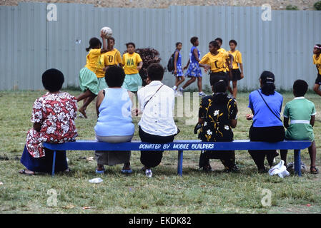 School children and parents watching a girls netball match at Churchill Park. Lautoka. Fiji. South Pacific. Stock Photo