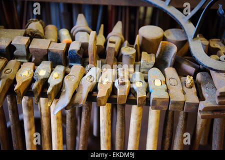 Variety of hammers in rack as used by blacksmith at Westpoint Forge, UK Stock Photo