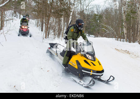 CBP Office of Border Patrol conducts cold weather operations in the Wellesley Island, Alexandria Bay and Clayton region of New York along the border of the United States and Canada. Border Patrol Agents patrol through the woods on snowmobiles.  James Tourtellotte Stock Photo