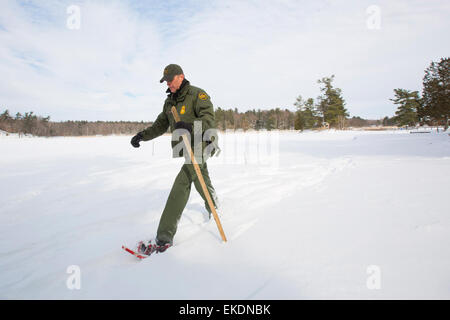 CBP Office of Border Patrol conducts cold weather operations in the Wellesley Island, Alexandria Bay and Clayton region of New York along the border of the United States and Canada. A Border Patrol Agent walks the area near the U.S. Canadian border.  James Tourtellotte Stock Photo