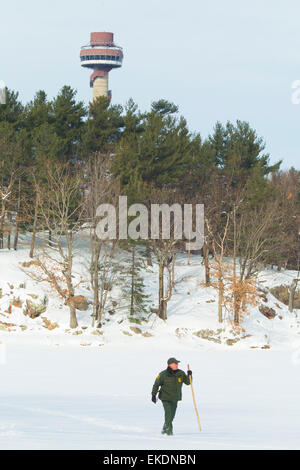 CBP Office of Border Patrol conducts cold weather operations in the Wellesley Island, Alexandria Bay and Clayton region of New York along the border of the United States and Canada. A Border Patrol Agent walks the area near the U.S. Canadian border.  James Tourtellotte Stock Photo