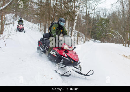 CBP Office of Border Patrol conducts cold weather operations in the Wellesley Island, Alexandria Bay and Clayton region of New York along the border of the United States and Canada. Border Patrol Agents patrol through the woods on snowmobiles.  James Tourtellotte Stock Photo