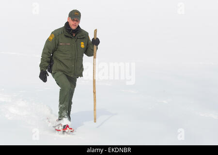 CBP Office of Border Patrol conducts cold weather operations in the Wellesley Island, Alexandria Bay and Clayton region of New York along the border of the United States and Canada. A Border Patrol Agent walks the area near the U.S. Canadian border.  James Tourtellotte Stock Photo