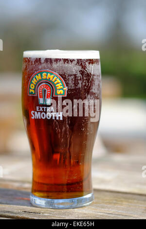 Cold pint of John Smith's extra smooth beer Stock Photo