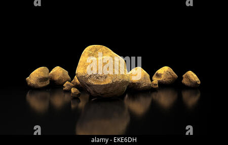 A collection of gold nuggets on an isolated dark background Stock Photo