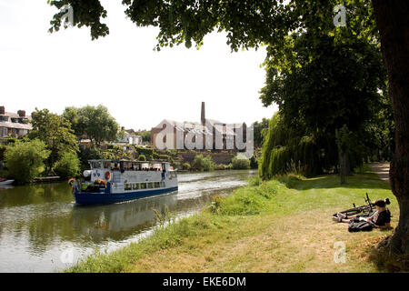 A person watching the pleasure boat Sabrina taking tourists along the River Severn in Shrewsbury, Shropshire during the summer of 2014. Stock Photo