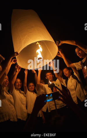 CHIANG MAI, THAILAND - OCTOBER 25, 2014: Group of young Thai people launch a sky lantern during the annual yipeng festival. Stock Photo