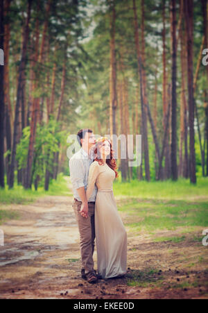 Gentle couple on romantic date, wedding day ceremony in the forest, tender feelings, enjoying spring nature and each other Stock Photo