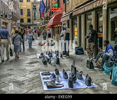 Venice, Province of Venice, ITALY. 6th Oct, 2004. On the streets of Venice immigrant African peddlers show their merchandise. Venice is one of the most popular international tourist destinations. © Arnold Drapkin/ZUMA Wire/Alamy Live News Stock Photo