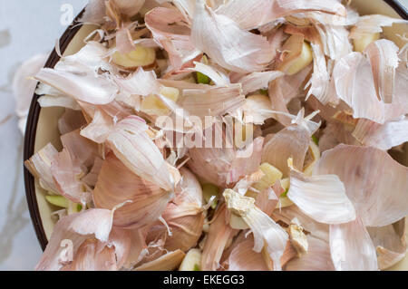Peel the garlic cloves in a bowl close-up view from above Stock Photo