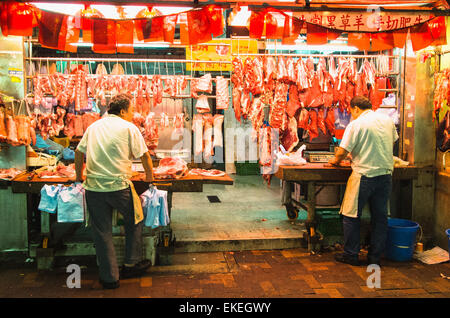 Butchers at night market of Hong Kong, China. Stock Photo