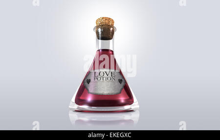 A regular old goblet glass bottle filled with a pink liquid with a label showing it is love potion and sealed with a cork on an Stock Photo