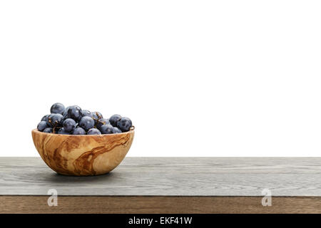 isabella grapes in wood bowl on table, border compostition Stock Photo